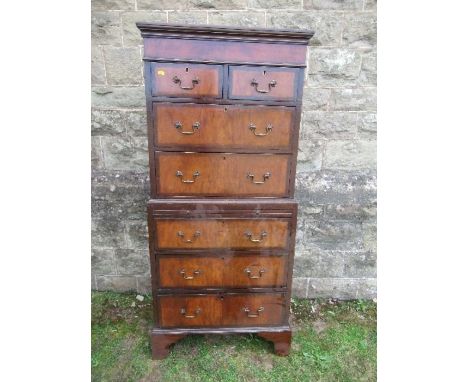 A mahogany and walnut tallboy, fitted with two short drawers over two long drawers to the top section, above a brushing slide