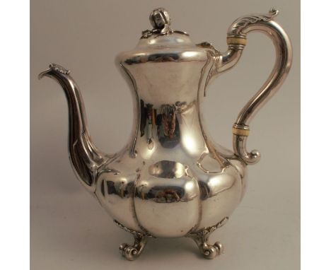 A Victorian silver coffee pot, of baluster form with shaped lower body, having a melon finial and leaf moulding to the spout 