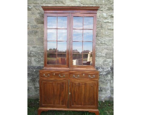 A 19th century design mahogany glazed cabinet, the upper section having glazed doors opening to reveal shelves, over two shor