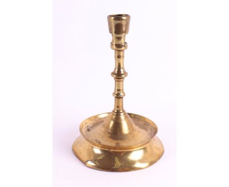A brass button candlestick, Southern Netherlands, 15th century. The conical candle mouth with two rectangular openings, stem 