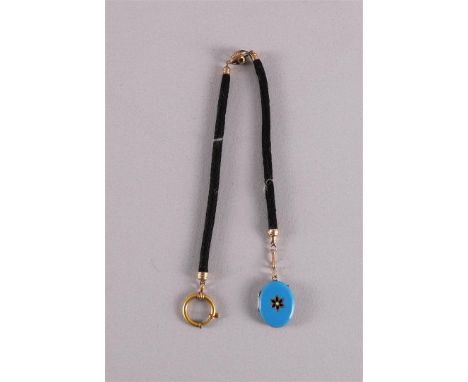 A watch chain on medallion pendant in gold mounting, circa 1900.