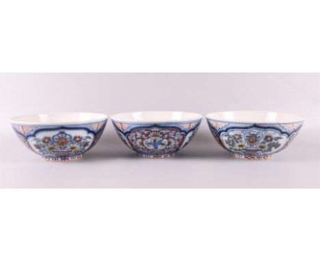 A series of three earthenware bowls on stand ring, Friesland, Makkum, 20th century. Polychrome floral decor, h 7.5 x Ø 18 cm,
