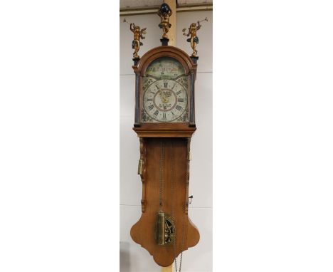 A Frisian tail clock, Friesland, mid 19th century. Oak case, the curved hood is crowned by Atlas and trumpet blowing angels, 