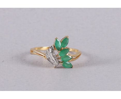 An 18 carat 750/1000 gold ring with 5 marquise cut emeralds and 2 diamonds. Ring size 18.25 mm.