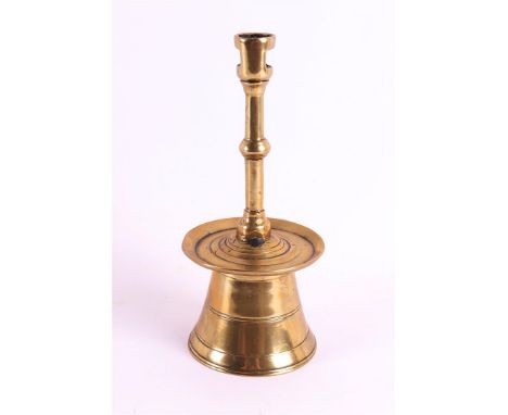 A brass button candlestick with bell, Southern Netherlands, 15th century. The cylindrical mouthpiece with two rectangular ope