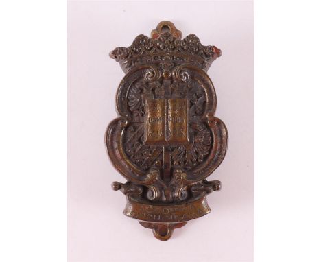 A bronze door knocker of the State University 'Academia Groningana', 19th century, h 9.5 cm.