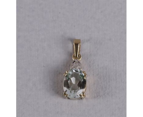 An 8 kt BWG vintage pendant with an oval faceted aquamarine and a diamond.