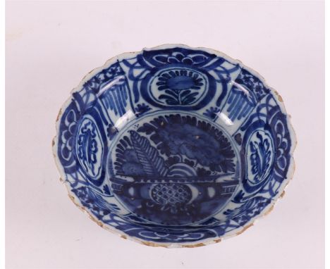 A blue and white Delftware hooded bowl, after a Wanli example, Holland, 18th century. Blue underglaze floral decor, h 4.5 x Ø