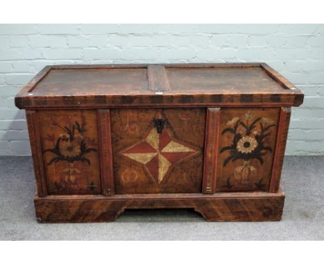 A 19th century North European polychrome painted pine trunk, with twin panel lid over triple panel front,resting on a stand, 