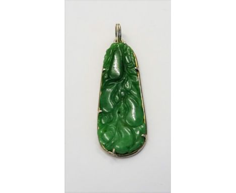 A silver mounted jade drop shaped pendant, with carved and pierced decoration, designed as fruit. 