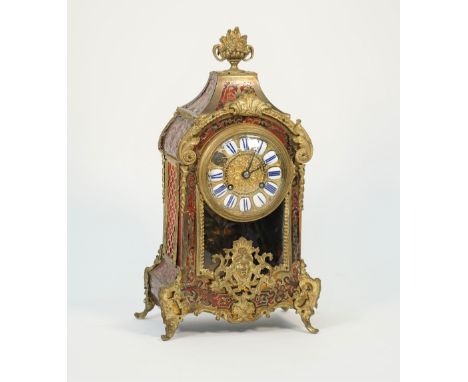 A french Boulle work mantel clock, late 19th century, with foliate finial, enamel numerals, glazed pendulum aperture and a tw
