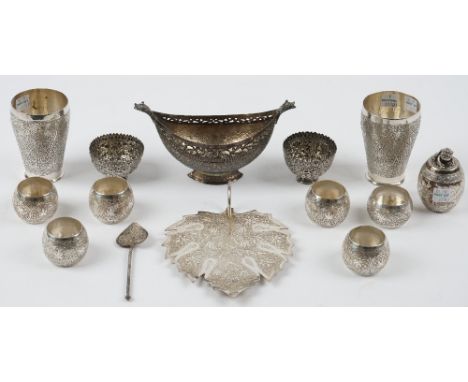 A group of Persian and Asian wares, comprising; a twin handled boat shaped dish, a leaf shaped dish, a pair of beakers, a pai