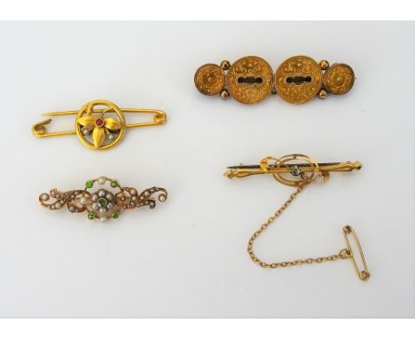 A gold, demantoid garnet and seed pearl set brooch, in a scroll pierced openwork design, detailed 15 CT , gross weight 4.4 gm