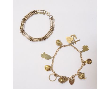 A 9ct gold oval link charm bracelet, with a 9ct gold heart shaped padlock and a boltring clasp, fitted with nine mostly 9ct g