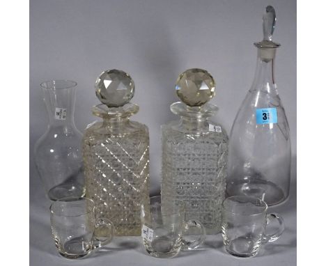 A glass decanter with engraved label, 'White', two square glass spirit decanters, a carafe and three glass cups, (7). 