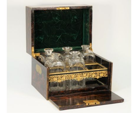 A 19th century brass inlaid coromandel decanter box, the rectangular lift top and full front revealing a six division interio