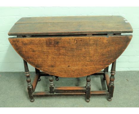 A 17th century oak gate leg dining table on baluster turned supports, 92cm wide x 70cm high. 