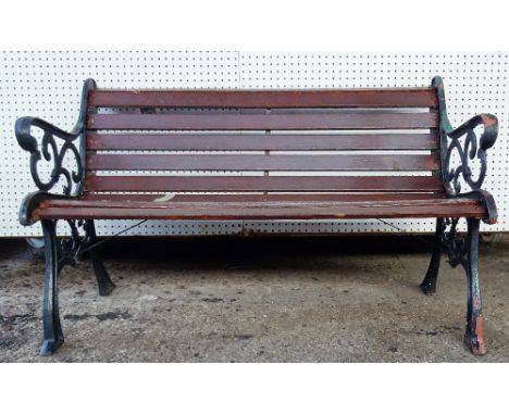 A 20th century black painted cast iron garden bench with scroll ends and wooden slats, 128cm wide x 78cm high. 