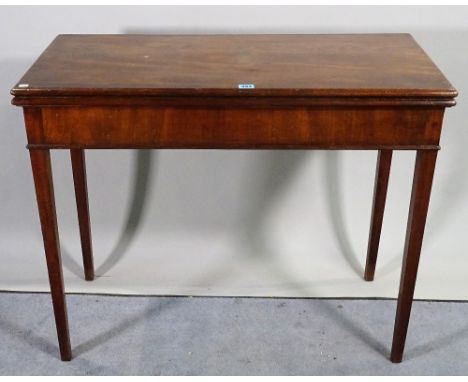 A late George III mahogany foldover card table on tapering square supports, 89cm wide x 73cm high. 