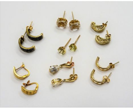 A pair of gold earrings of curved design, detailed 18 K, weight 1 gm and six further pairs of mostly gold and gem set earring