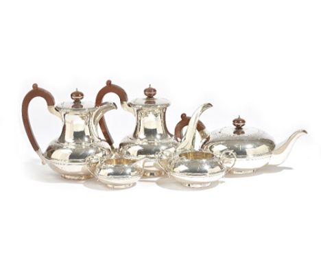 A silver five piece tea and coffee set, comprising; a teapot, a hot water jug, a twin handled sugar bowl and a milk jug, Lond