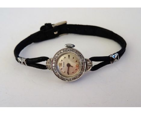 A Bucherer white gold and diamond set lady's dress wristwatch, the signed silvered dial with dot, Arabic and arrow shaped num