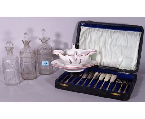 A group of three late 18th century glass decanters, a silver plated cased flatware and 'Luneville' ceramic sauce boat decorat