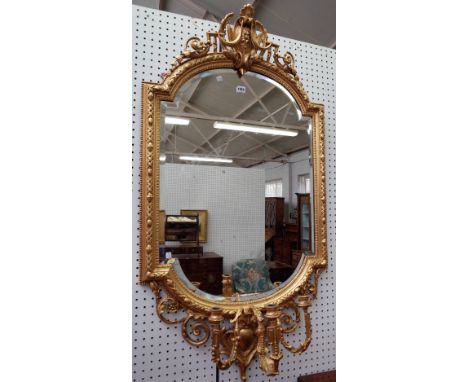 A 19th century gilt framed girandole wall mirror, with cartouche crest over shaped plate and triple branch candlestick, 70cm 