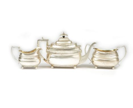 A silver composite three piece tea set, comprising; a teapot, London 1807, a twin handled sugar bowl, London 1815 and a milk 