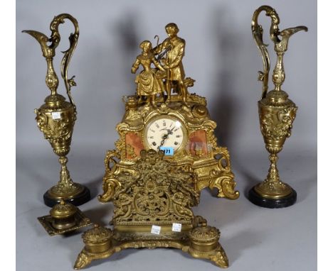 A 20th century Continental gilt metal mantel clock with eight day movement, the scroll moulded case surmounted with a courtin