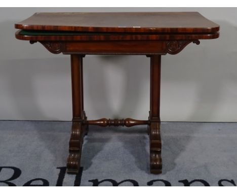 A Regency mahogany card table, the fold over 'D' shaped top on a pair of trestle supports, 92cm wide x 72cm high. 