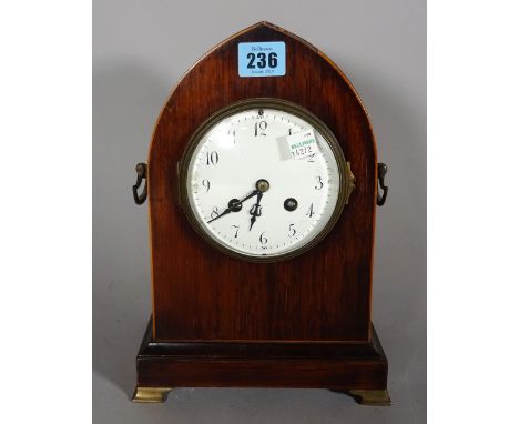 An early 20th century mahogany cased clock of lancet form on brass bracket feet, 16cm wide x 27cm high.