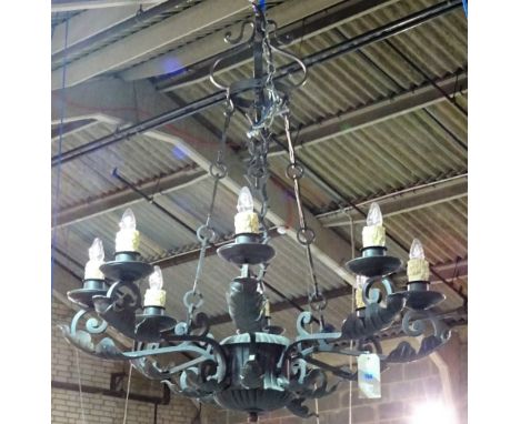 A pair of English wrought iron eight light chandeliers, late 20th century, each cage frame applied with large leaf foliage, s