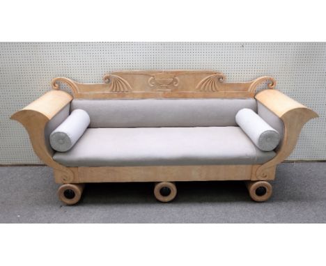 A Biedermeier birch sofa with urn and scroll crest and cornucopia arms on a trio of turned supports, 242cm wide x 102cm high.