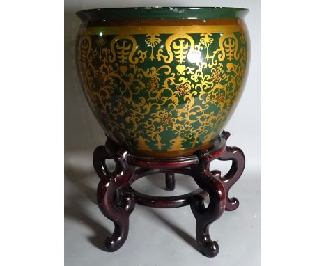 A 20th century ceramic jardiniere with gold foliate decoration on a hardwood stand, 42cm wide x 68cm high. 