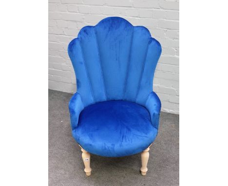 A Victorian style button back armchair, with studded blue upholstery, on turned supports, 65cm wide x 103cm high.