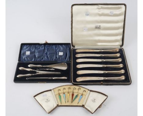 Six silver gilt and varicoloured enamelled cocktail sticks, designed as ladies umbrellas, five Birmingham 1932 and one Birmin