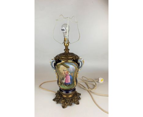 Porcelain and gilt table lamp with painted scenes, 17” to top of fitting