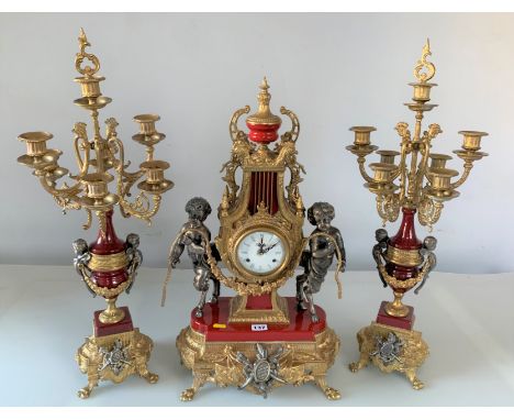 Reproduction brass &amp; red clock set comprising chiming battery run clock 24.5” high x 14” wide and pair of candelabra 27” 
