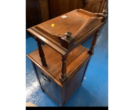 Carved mahogany coal cupboard with drop scuttle and shelf on top. 15.5” wide x 15” deep x 37.5” high. 