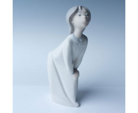 This Lladro porcelain figurine, titled "Girl Kissing," stands at 7.5"H and captures a tender, whimsical moment. Finished with