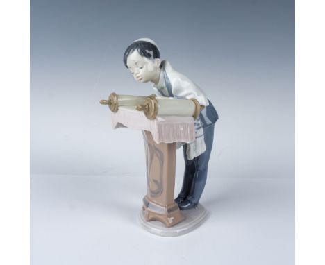 This exquisite Lladro porcelain figurine, titled "Bar Mitzvah," depicts a young boy reading from the Torah at a podium, symbo