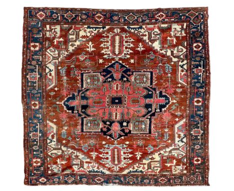 A strikingly vibrant rug in rich hues of blue, red and white, adorned with intricate geometric and nature inspired patterns t