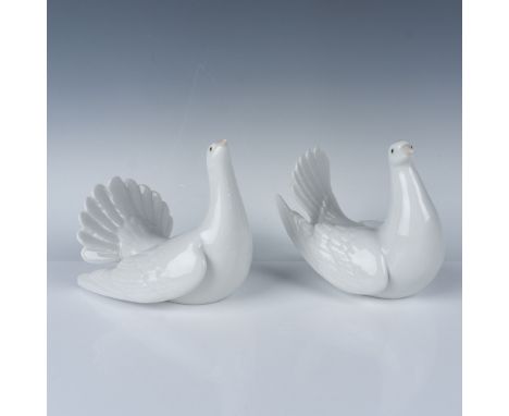 This lot features a stunning pair of iconic Lladro porcelain doves, titled "Peaceful Dove" and "Restless Dove." Each piece is