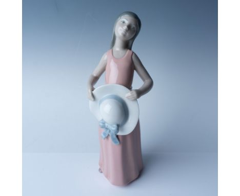 This exquisite Lladro porcelain figurine, titled "Dreamer" (Model No. 1005008), stands at 10" in height, this piece captures 