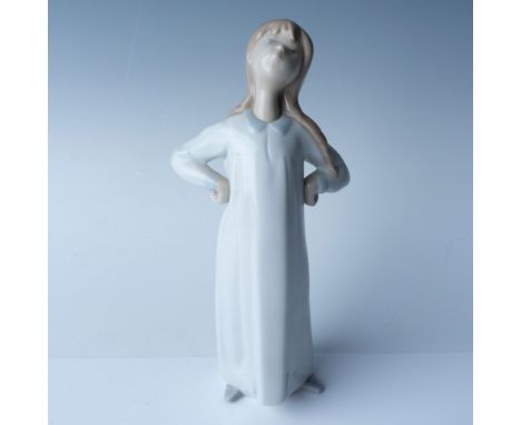 Lladro porcelain figurine titled "Girl Stretching," number 1004872. This piece, depicting a young girl with hands on her hips