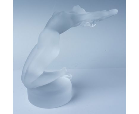 This Lalique crystal figurine, titled "Chrysis," is a beautifully sculpted representation of a nude female form. Standing at 