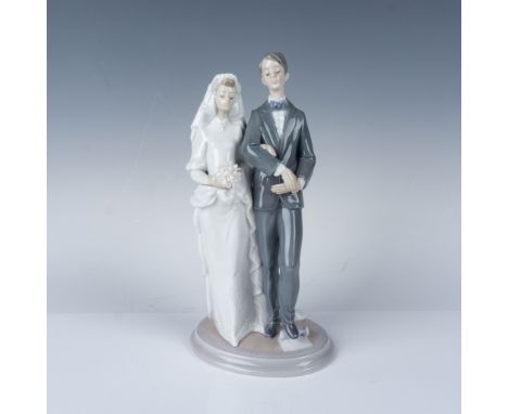 This is a stunning Lladro porcelain figurine titled "Mazel Tov,". The piece depicts a beautifully detailed bride and groom wa
