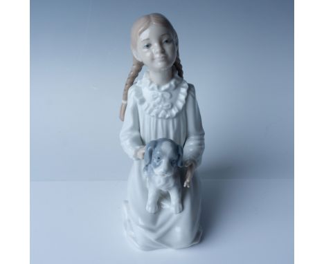 This Nao by Lladro porcelain figurine titled "Girl with Dog" (Item number 00171) features a young girl seated with a playful 