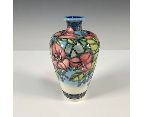 A stunning Moorcroft vase designed by Anji Davenport, featuring vibrant pink bougainvillea flowers with lush green foliage on